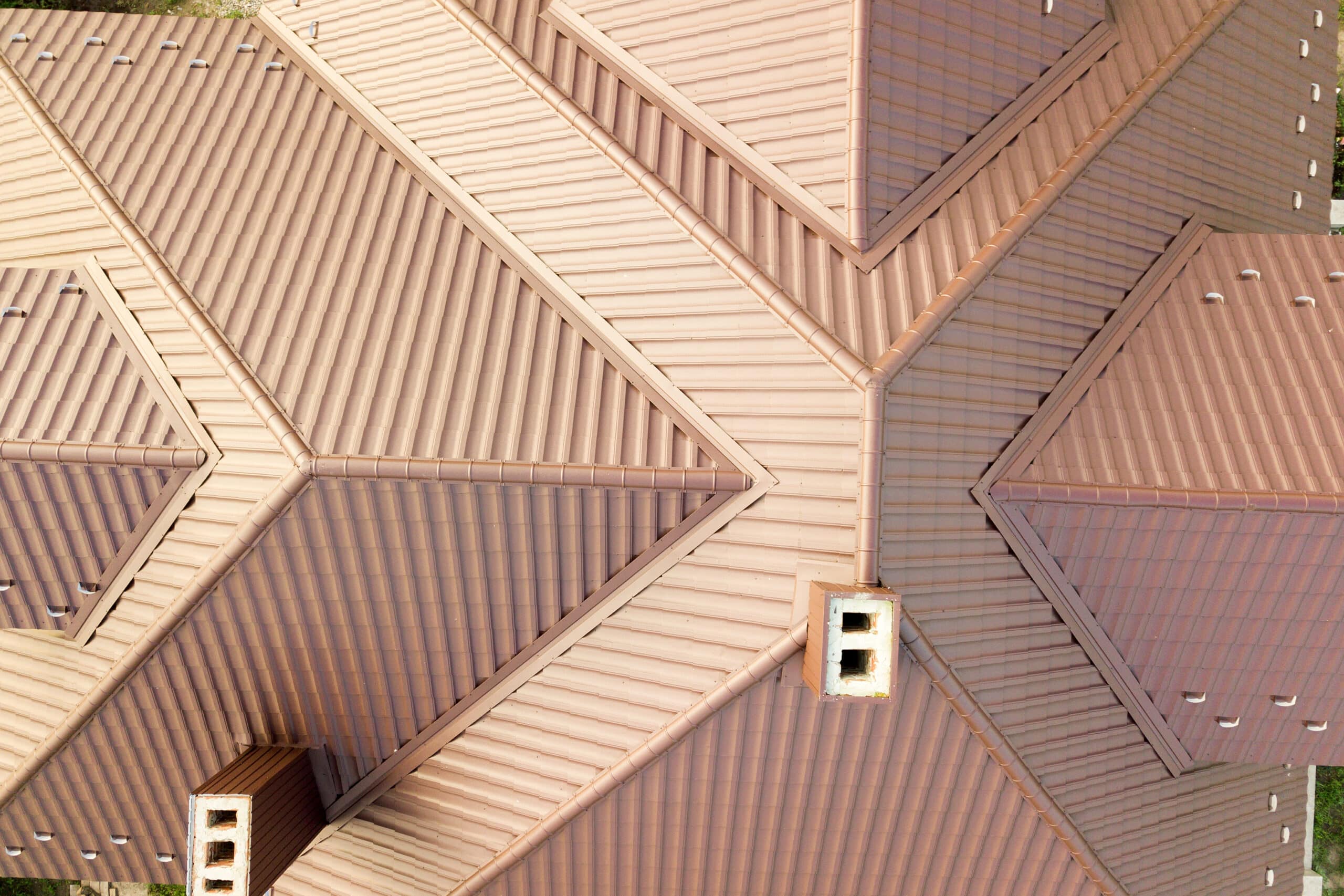 Aerial view of house roof structure covered with brown metal til - Roof EZ